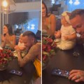 Jeziv snimak: Nejmar je zavisnik! Drži kćerku od šest meseci, a usred slavlja pokazao porok (video)