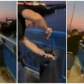 Traži se identitet ovih huligana iz Novog Sada koji su iz čistog mira isekli kante za đubre i bacili ih u Dunav (VIDEO)